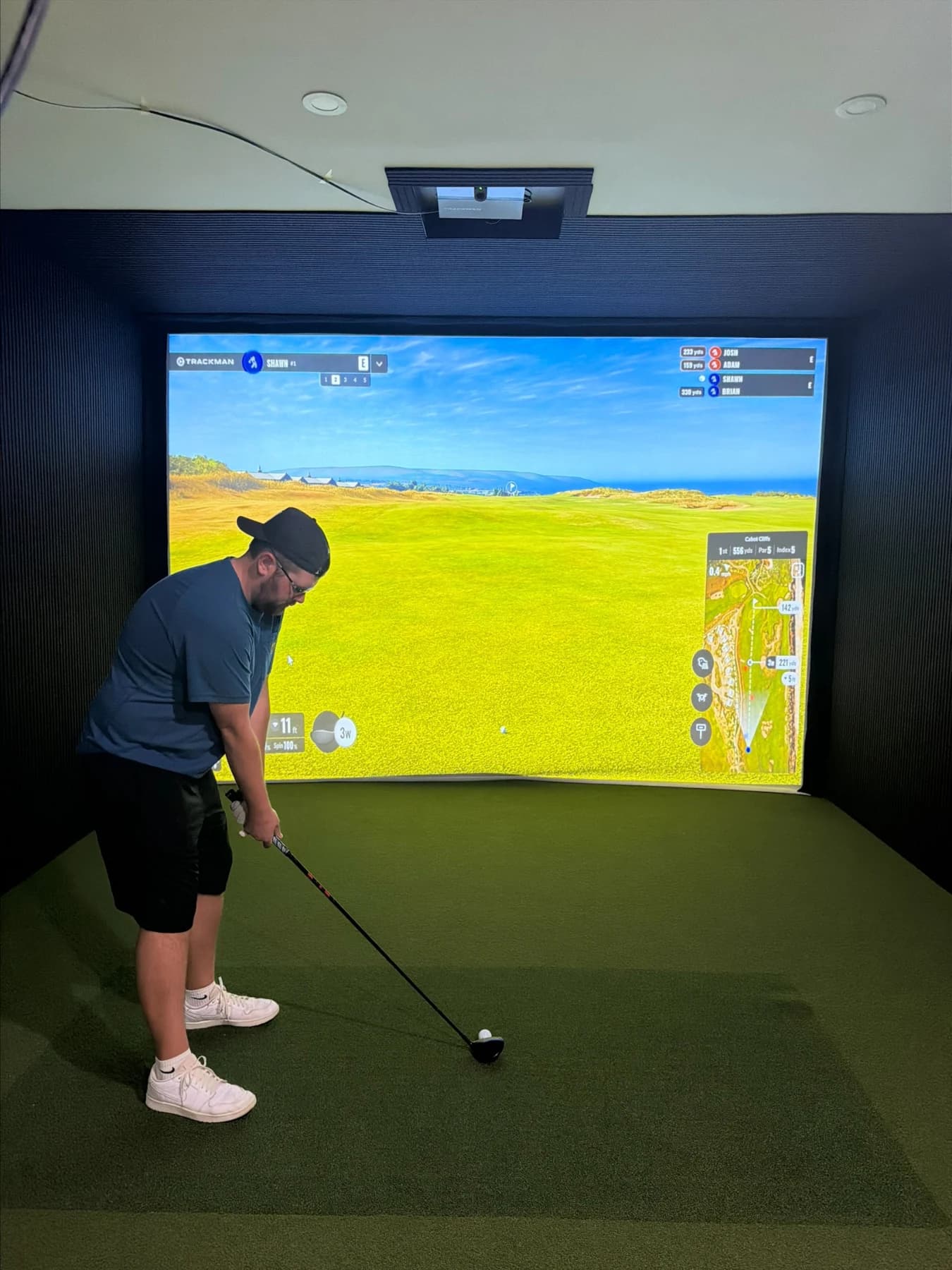 Golfer using a simulator at The Mulligan Room